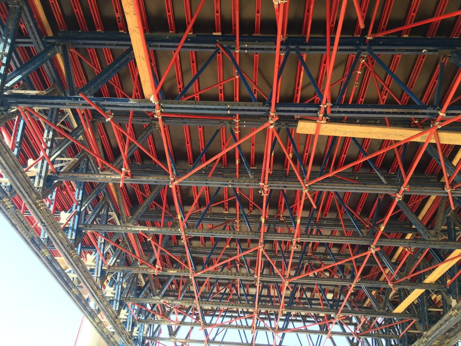 Diagonal and cross braces (in red) are used to strengthen and stabilize the temporary structure and resist lateral loads.