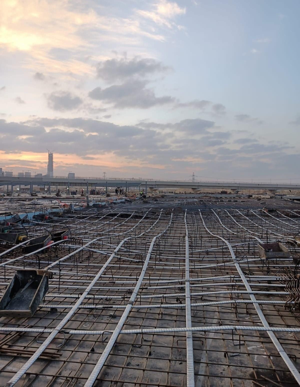 After the concrete hardens and reaches the required strength, the cables are tensioned using hydraulic jacks.